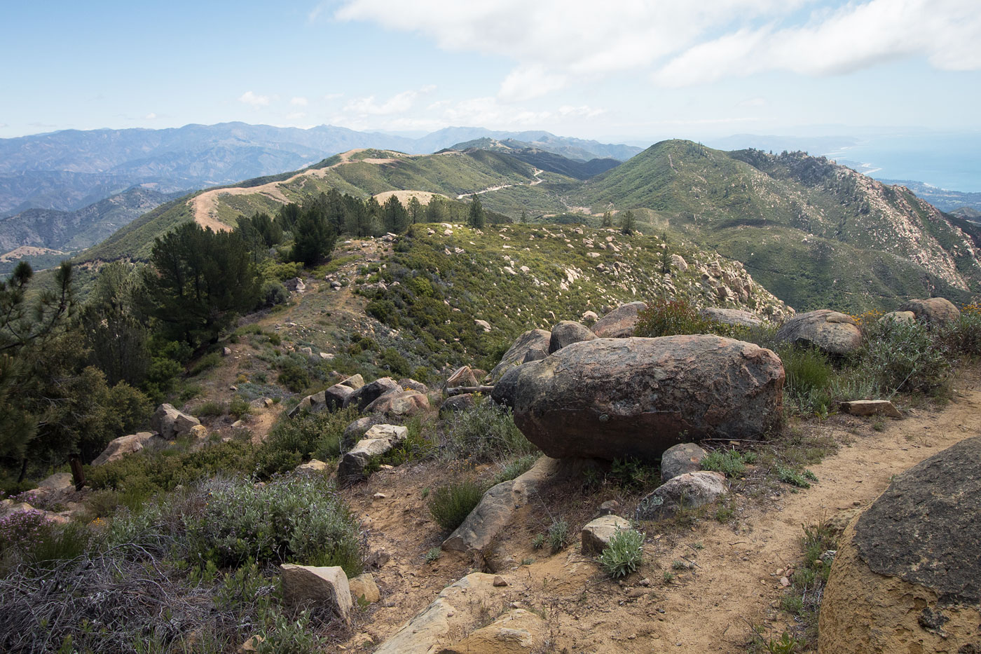Hiker on the trail to La Cumbre Peak in the Santa Ynez Mountains, showcasing the natural beauty and accessible hiking terrain